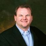 Headshot of Adam Williams, real estate agent