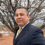 Headshot of Adrian Serrano, real estate agent
