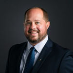 Headshot of Adrian Young, real estate agent